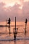 Silhouettes of the traditional Sri Lankan stilt fishermen on a stormy in Koggala, Sri Lanka. Stilt fishing is a method of fishing