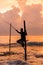 Silhouettes of the traditional Sri Lankan stilt fishermen on a stormy in Koggala, Sri Lanka. Stilt fishing is a method of fishing