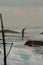 Silhouettes of the traditional Sri Lankan stilt fishermen on a stormy in Koggala, Sri Lanka. Stilt fishing is a method of fishing