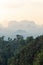 Silhouettes of tropical hazy mountains perspective and the green jungle trees