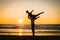 Silhouettes of two dancers doing acrobatics at sunset