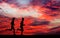 Silhouettes of two runners on fiery background