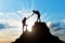 Silhouettes two women climber on top of the mountain.