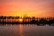 Silhouettes at U Bein teak bridge at sunset. Myanmar (Burma)