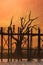 Silhouettes at U Bein teak bridge at sunset. Myanmar (Burma)