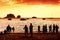 Silhouettes of unknown people watching red sunset