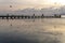 Silhouettes of unrecognizable people on a pier at sunset