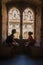 Silhouettes of woman and child in the shade, in front of a window in the Palace of the Popes of Avignon