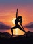 Silhouettes of woman do yoga at sunset scenery