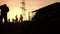 Silhouettes of workers at a construction site