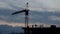 Silhouettes of workers on the top of residental building.