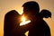 Silhouettes of young couple kissing