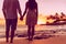 Silhouettes of young couple in love holding hands on honeymoon travel vacation summer holidays. Silhouette of people