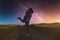 Silhouettes of a young couple in love under the starry sky with milky way