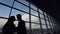 Silhouettes of young couple meeting in airport.