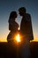 Silhouettes of young couple at sunset