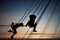 Silhouettes of young girls having fun on carousel