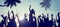 Silhouettes of Young People on a Beach Concert