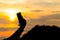 Silhouettes of young women sitting during sunset and take a selfie with smartphone. Hipster having fun on the beach.