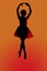 Silhouettr of a young balerina with an orange back