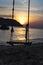 Silhoute of swing on the beach with sunset and sea,mountains view in Pho Quoc island