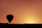 Silhoutte of balloon on sunrise. famous hot air balloon flying over valley. Goreme, Cappadocia, Turkey
