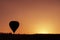 Silhoutte of balloon on sunrise. famous hot air balloon flying over valley. Goreme, Cappadocia, Turkey