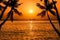 Silhoutte coconut palm trees with silhoutte fisherman boat on tropical sea in sunset