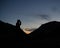 Silhoutte of Hiker Drinking from Mug in the Mountains