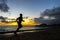 Silhoutte of runner jogging along Waikiki beach