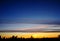 Silhoutte of tree and islands at far with vivid color of the sky during sunset