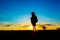 Silhoutte of woman hiker over sunset sky