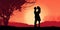 Silhuette of couple, man and woman, standing against the sky and beautiful sunset. Love celebration, engegement, happy end