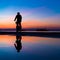 Silhuette of Man on Bicycle and his reflection on water from rain, against Lovely Colors Sky