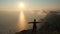 Silhuette Young Woman arms outstretched observing a beautiful dramatic sunset above a sea from a high mountain in Crimea