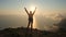 Silhuette young woman arms outstretched observing a beautiful dramatic sunset above a sea from a high mountain in Crimea