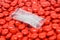 Silica gel in bag on red sugar coated pills tablets vitamin