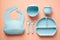 Silicone baby self feeding utensils Toddler dinnerware set on color background. Flat lay, top view