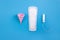 Silicone yellow menstrual cup with pads and tampon. Women\\\'s health and alternative hygiene on a pink background