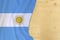 Silk colored national flag of Argentina country, empty wooden mocap for text, concept of tourism, travel, emigration, global