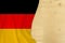 Silk colored national flag of Germany country, empty wooden mocap for text, concept of tourism, travel, emigration, global