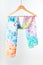 Silk colourful hand painted tied scarf put on white background. Woman fashion, tying a scarf, wearing a scarves. Stylish ways to