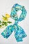 Silk colourful hand painted tied scarf put on white background. Woman fashion, tying a scarf, wearing a scarves. Stylish ways to
