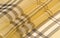 Silk fabric champagne pale fawn Tartan checkered wallpaper patterns. Scottish checkered dress. Textile pattern of classic