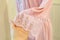 Silk pink women peignoir on yellow background. Fashion women underwear. Satin Women`s nightgown. fashionable lingerie