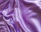 Silk purple fabric background drapery, satiny textile, decor curve, wave, material