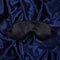 Silk sleep mask on silk background