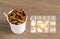 Silkworm Pupae insects for eating as food with icons media nutrition. Chrysalis silk worm deep-fried snack in disposable cup for