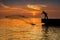 Sillhouette fisherman and sunset on bridge