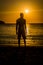 Sillhouette of a man in the beach during sunset